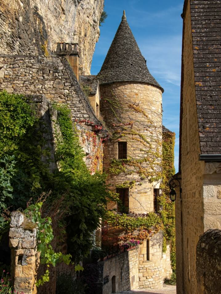 Ivy covered historic chateau in Dordogne, France.
