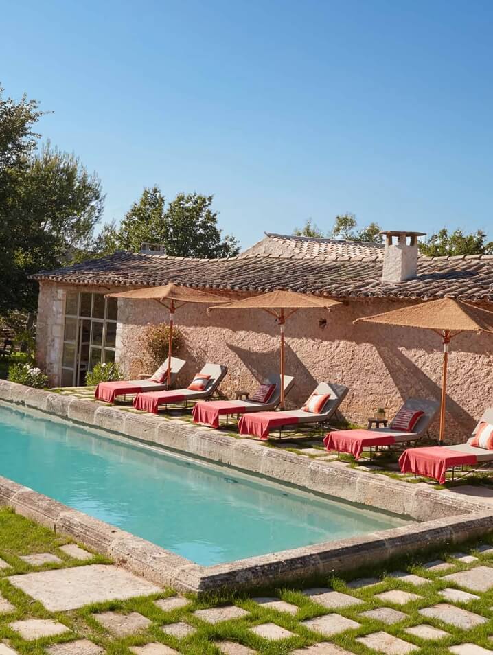 Charming rustic pool at Hotel Bastide de Marie in Provence, France with warm stone surroundings and countryside ambiance.