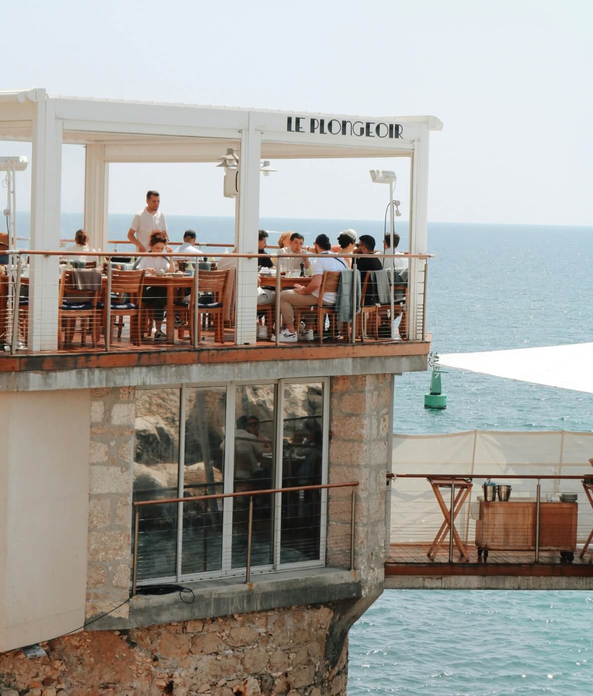 Le Plongeoir, a stone built port restaurant, offers rooftop dining in Nice and is perched above the glittering, topaz Mediterranean Sea.