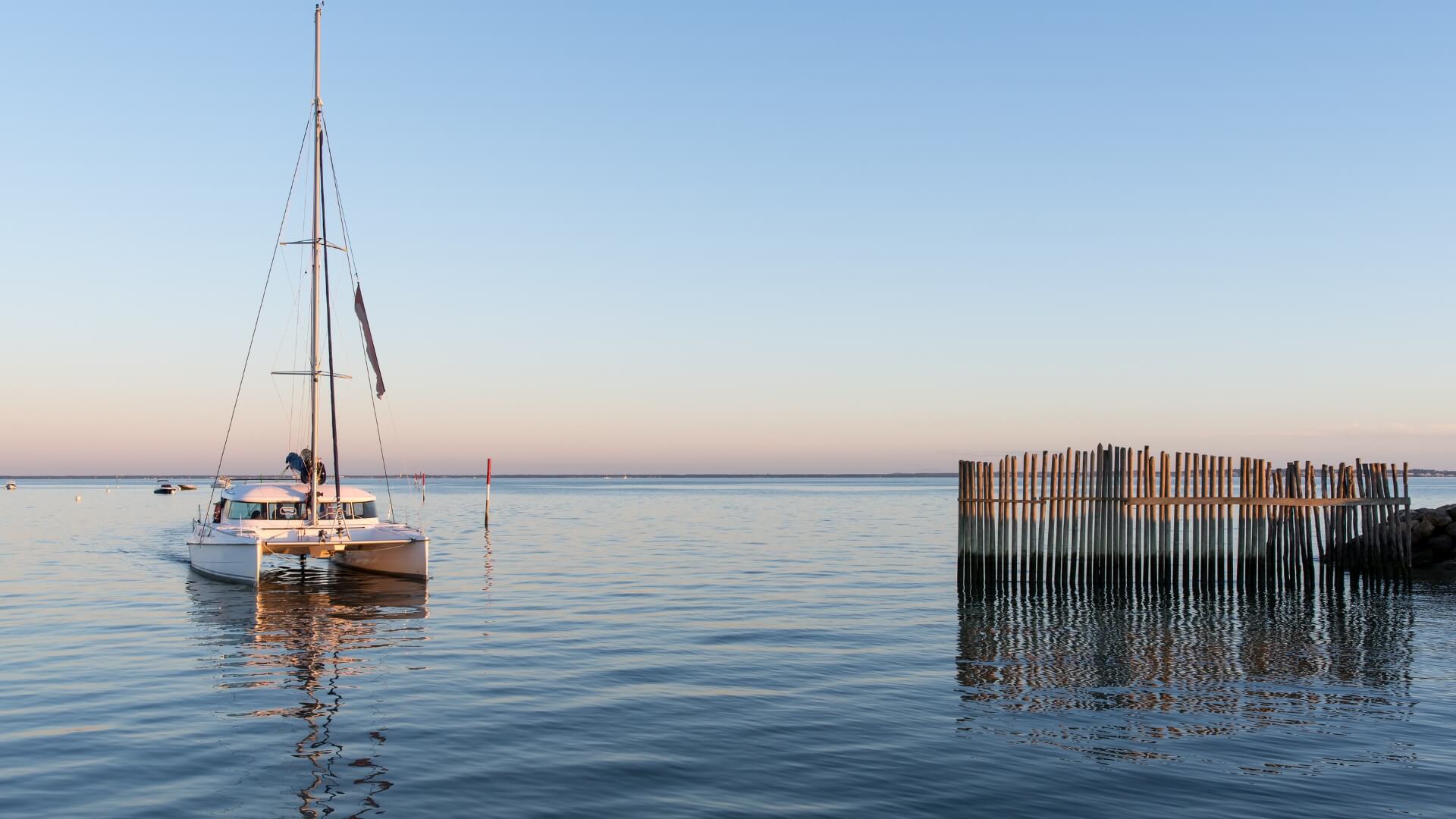 A sunset view of a boat in the Bay of Arcachon.