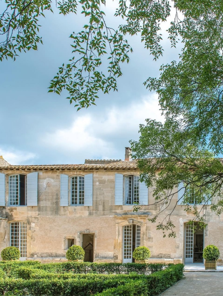 A stone, window filled home, overlooking a French garden.