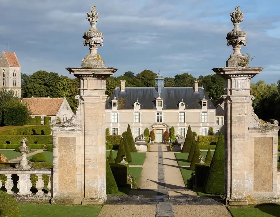 Chateau de Bercy's estate and traditional French gardens are framed by stone gates and pillars.