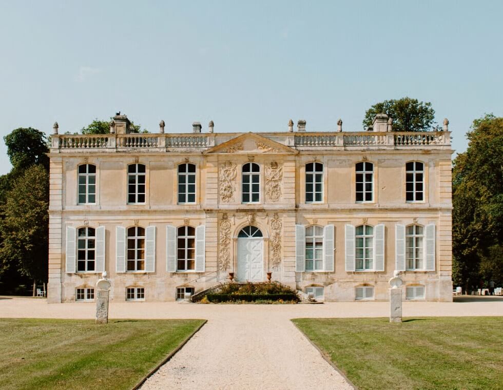 The Canon Château is an expansive two-story estate, lined with shutter-clad windows and a neatly kept front garden.