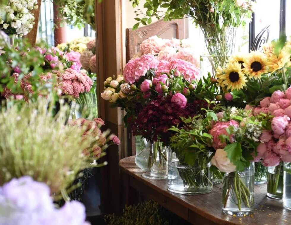 Fresh cut peonies and summer blooms in Parisian floral shop L'Arrosoir.