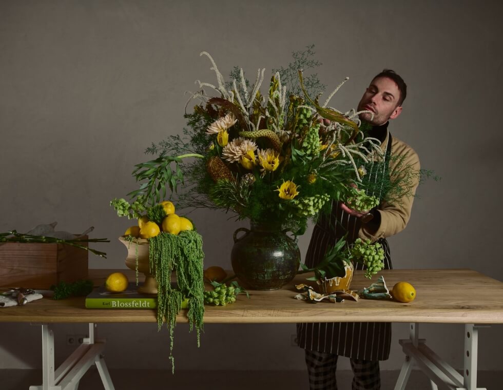 Elegant floral bouquet styled with lemons and greenery by florist at Maison Ciero in Paris.