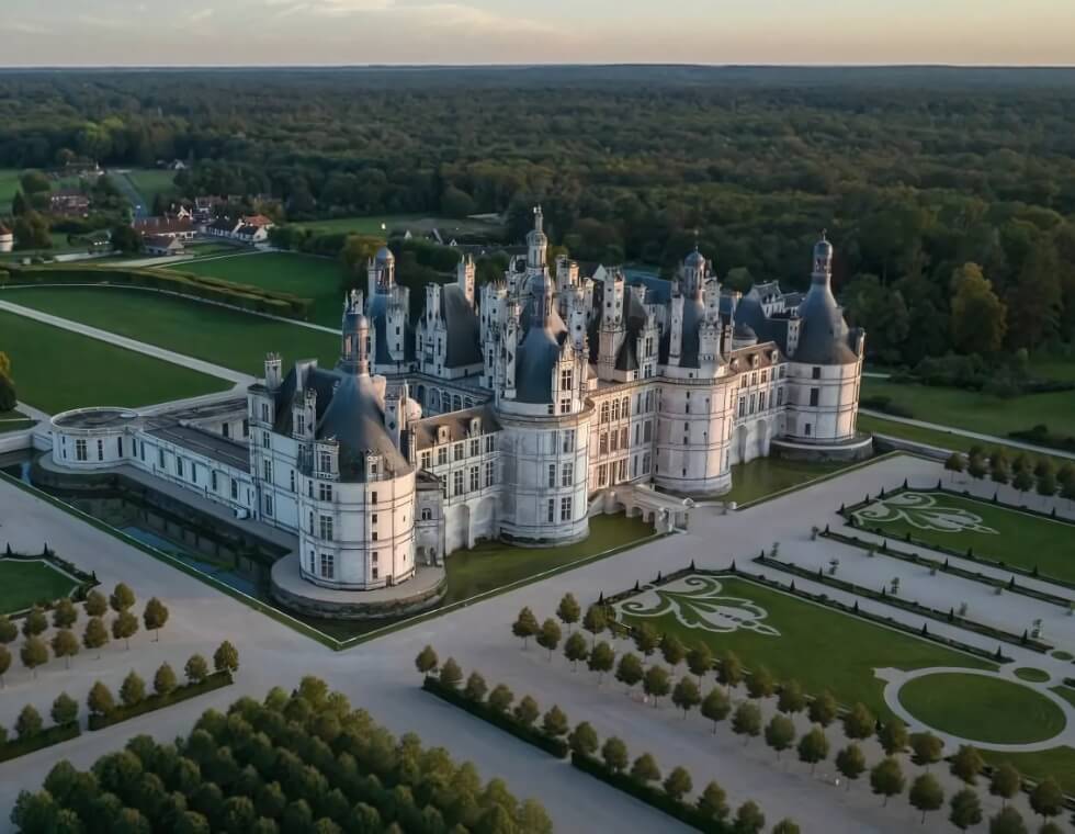View of Chambord Castle, with manicured traditional French gardens spanning the estate.