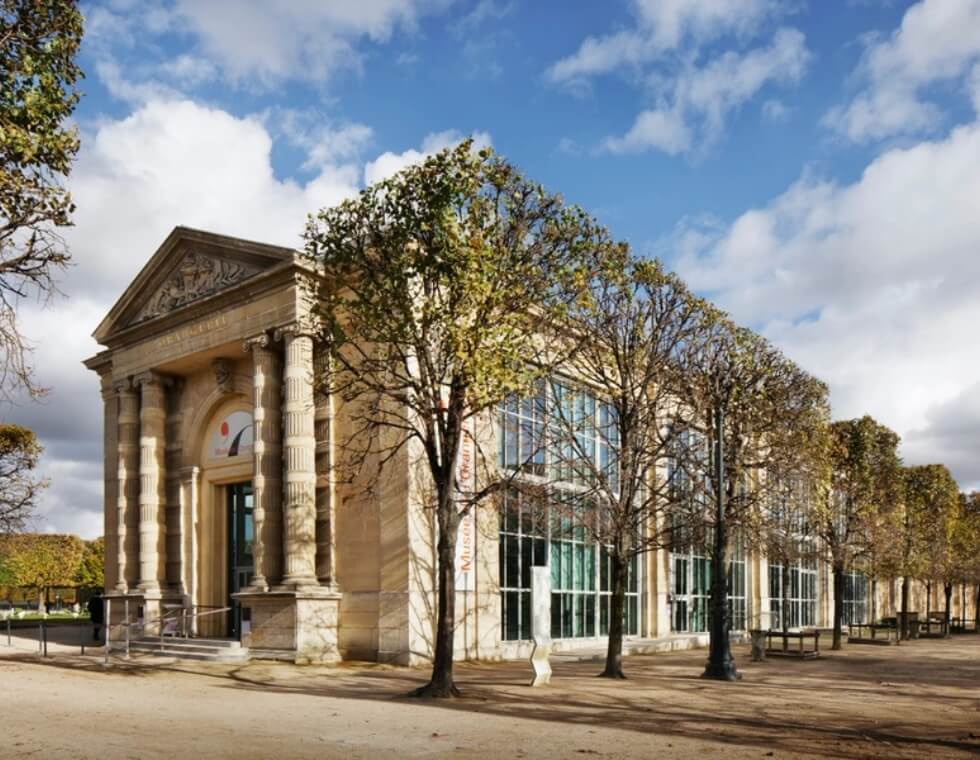 L'Orangerie Museum located in the Parisian Tuileries Gardens, surrounded by manicured trees.