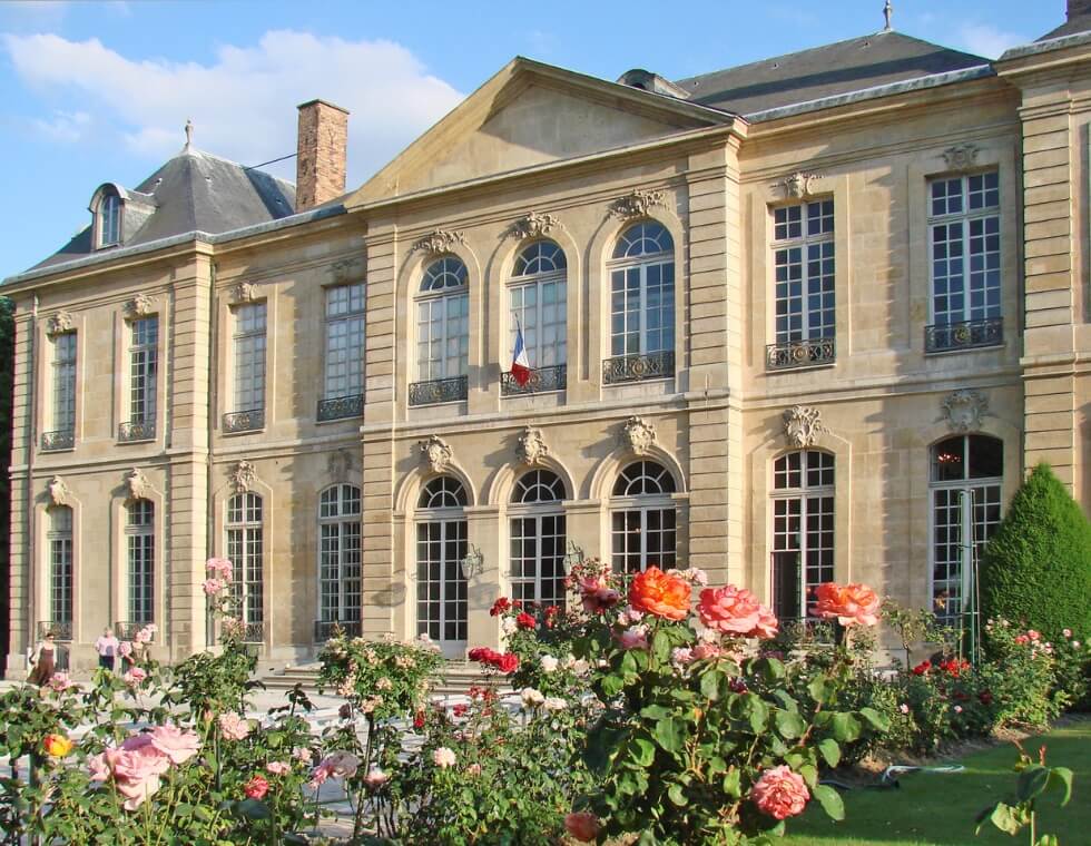 Rodin Museum garden in Paris, France, featuring colorful blooming roses.