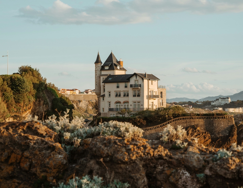 Biarritz, on the southwest coast of France, with historic buildings along the rocky landscape.