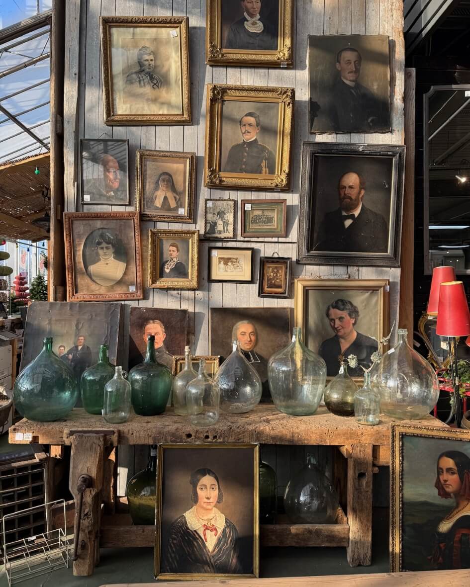 French outdoor market in Normandy featuring selection of portraits for sale.