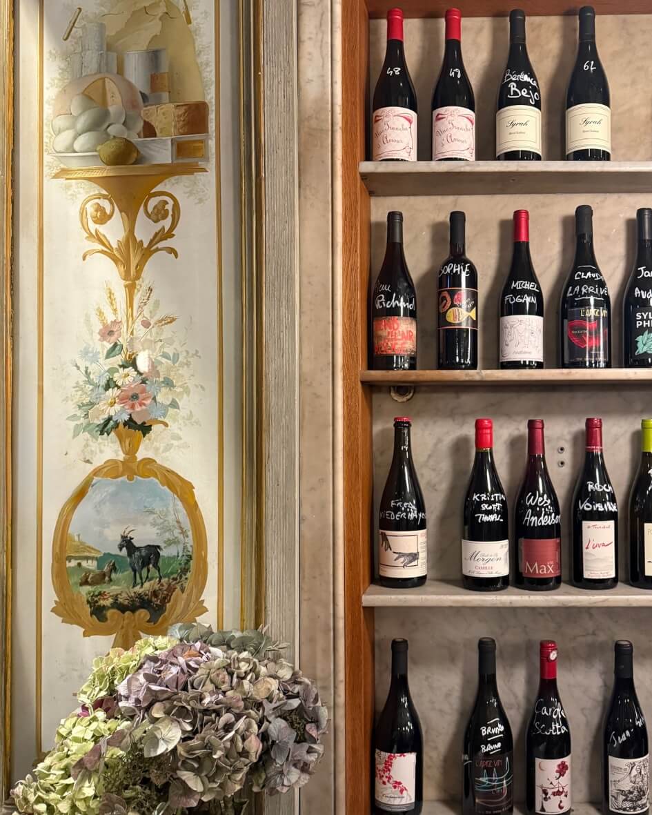 Interior of a wine store in Normandy, France, with elegantly painted countryside motifs.