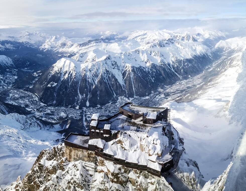 Chamonix ski resort perched on a snowy mountain, surrounded by the rugged peaks of the French Alps.