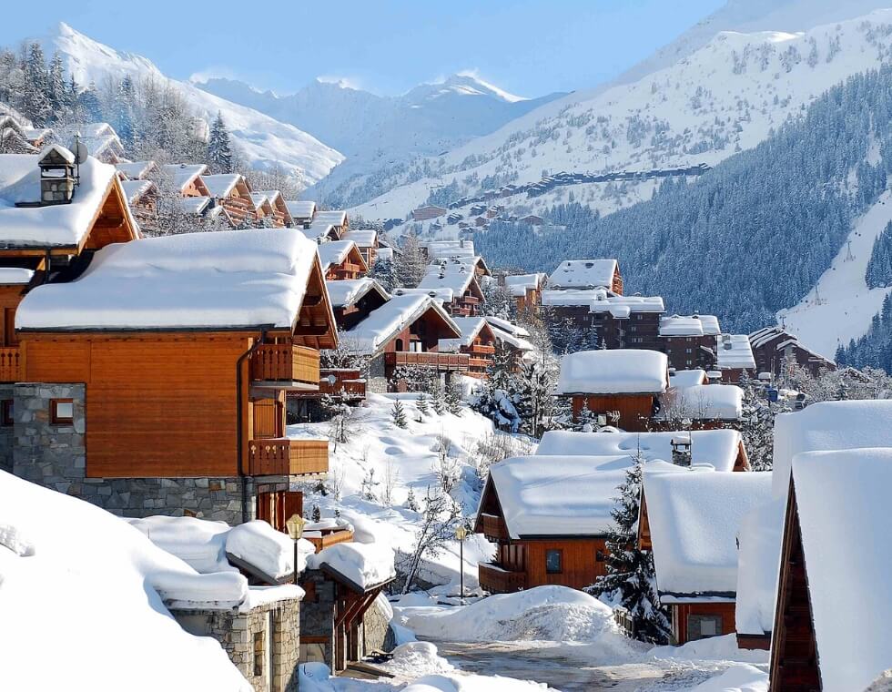 Snow-covered chalets at Meribel ski resort in the French Alps.