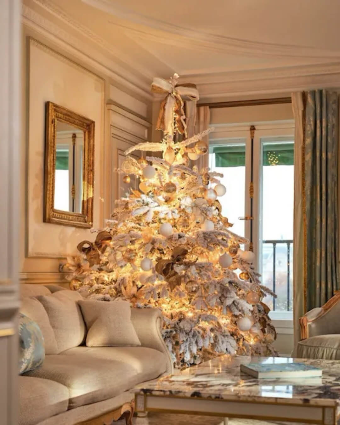 Le Meurice luxury hotel room interior in Paris, France featuring a decorated Christmas tree in a cozy salon.
