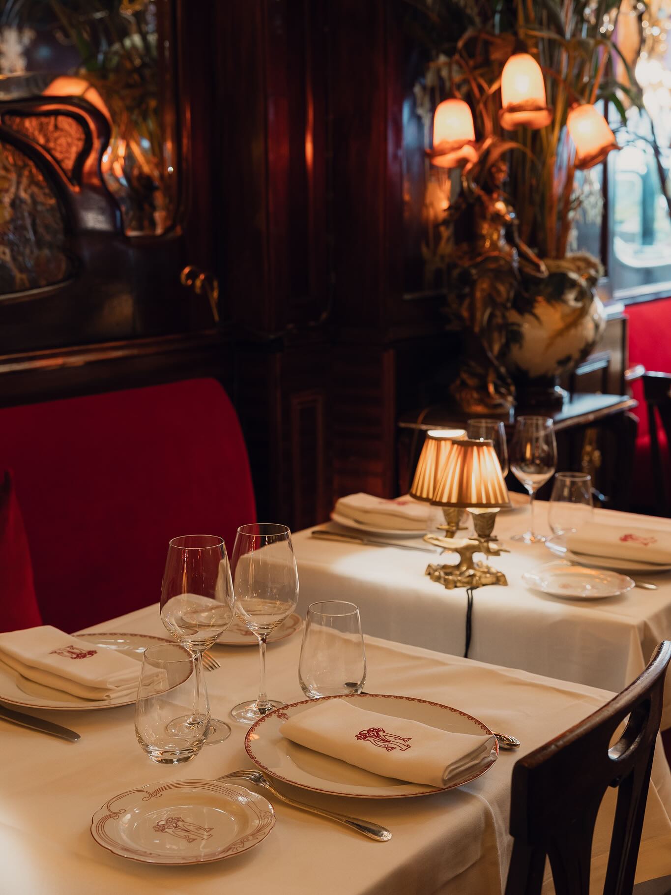 Maxim's restaurant in Paris, France with belle epoch and art deco design accents, cozy seating, and soft light.