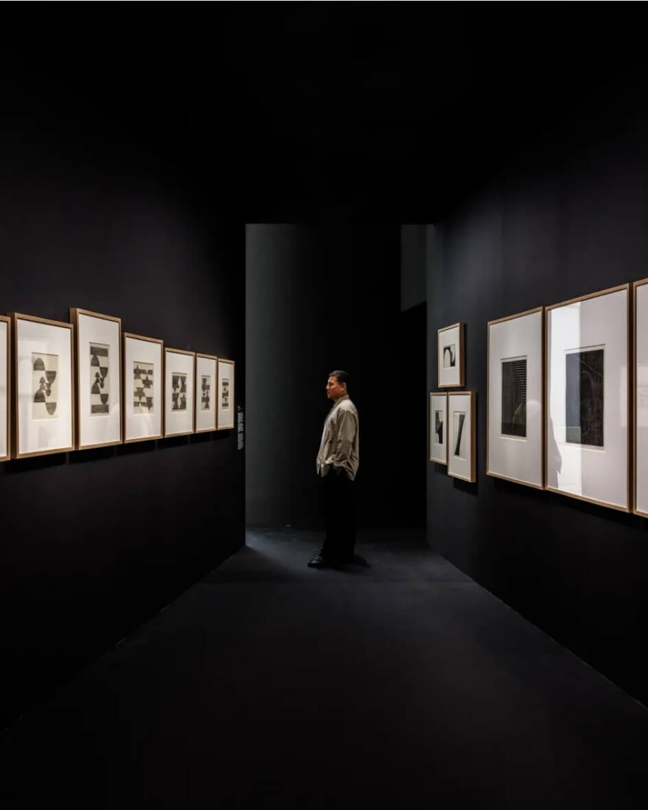 Bourse de Commerce contemporary art exhibition in Paris, France with framed photos along the walls.