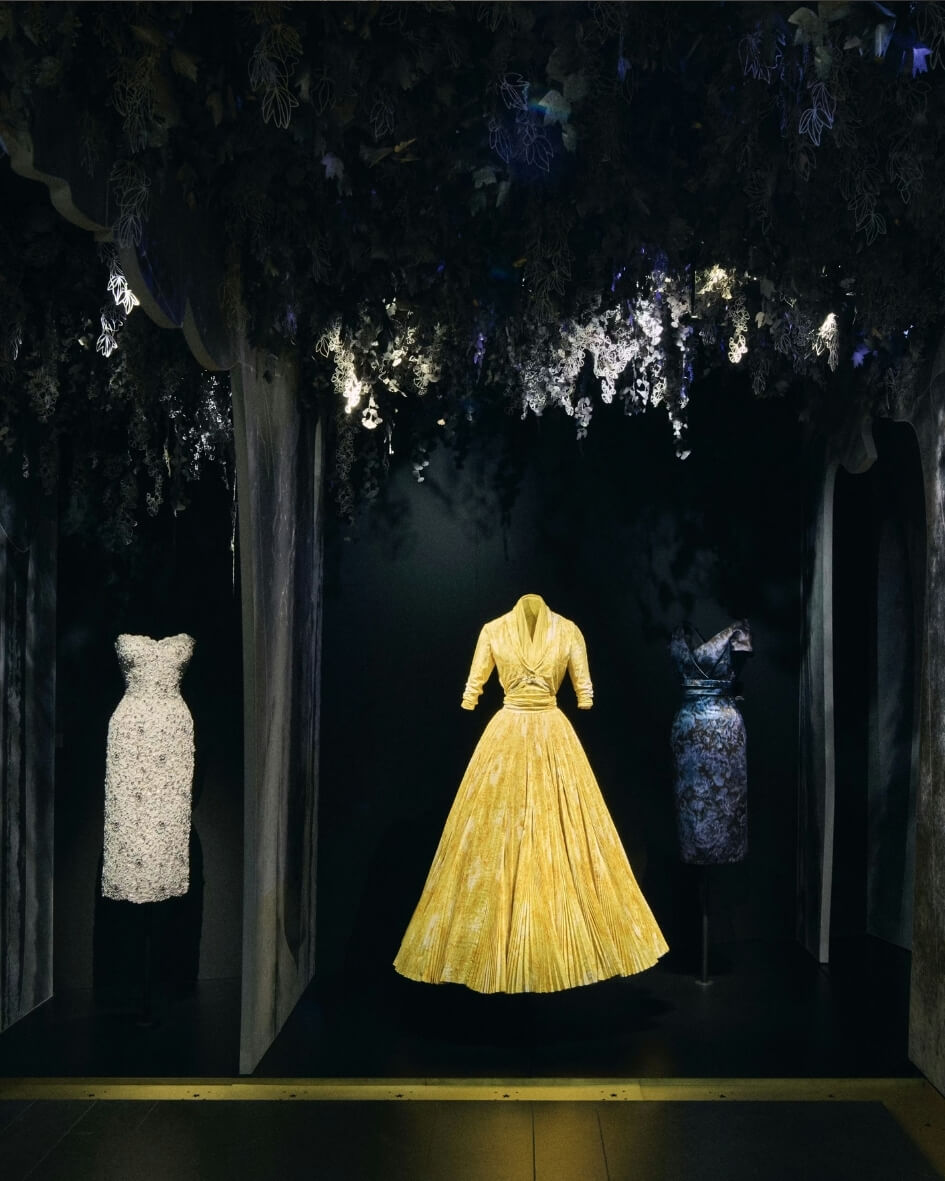 Gallerie Dior in Paris, France featuring original Christian Dior couture dresses displayed on mannequins.