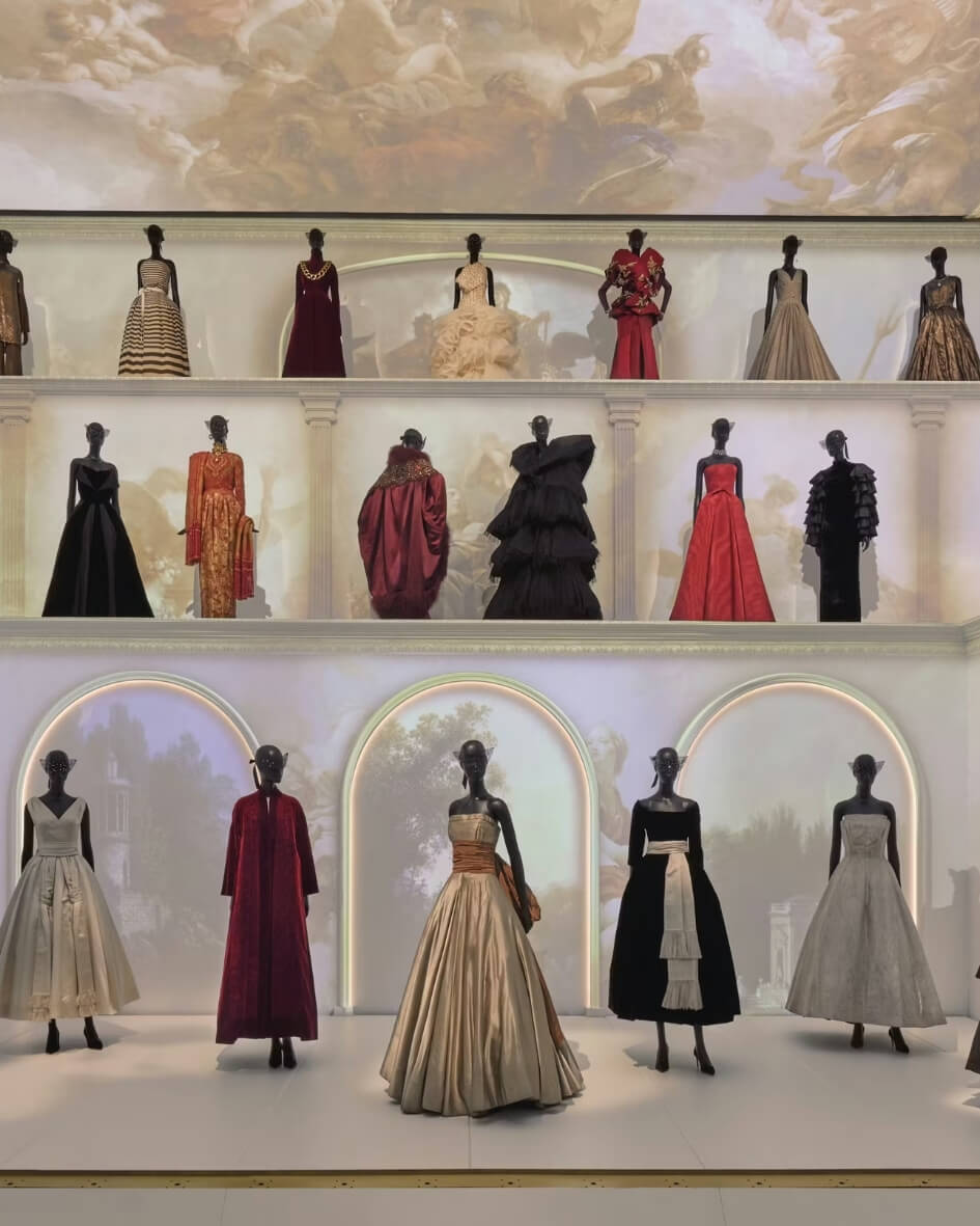 Gallerie Dior showroom in Paris, France with elegant archival dresses on display.
