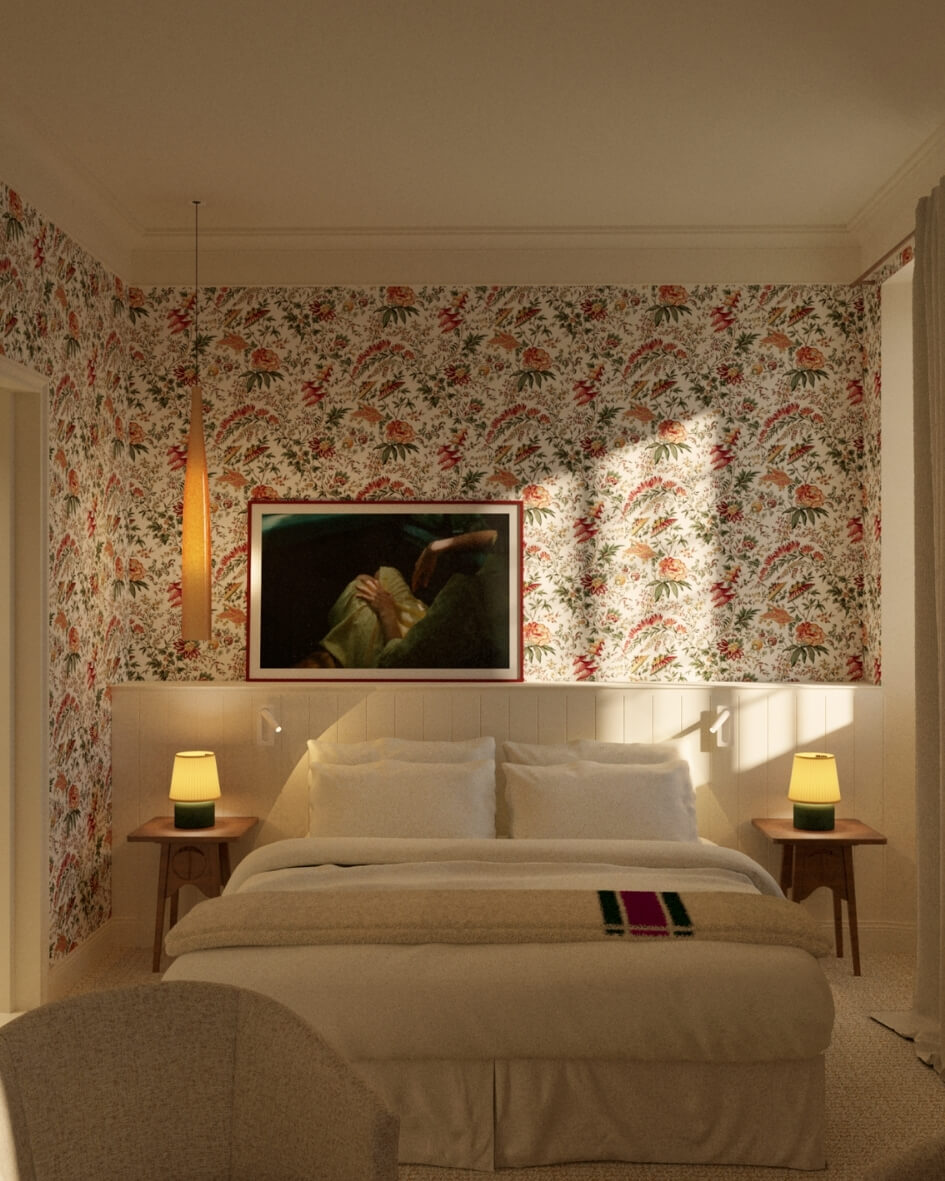 Interior of a room at Les Sources de Vougeot boutique hotel in Burgundy, France, featuring ornate wallpaper, mid-century modern accent tables, and plush bedding.