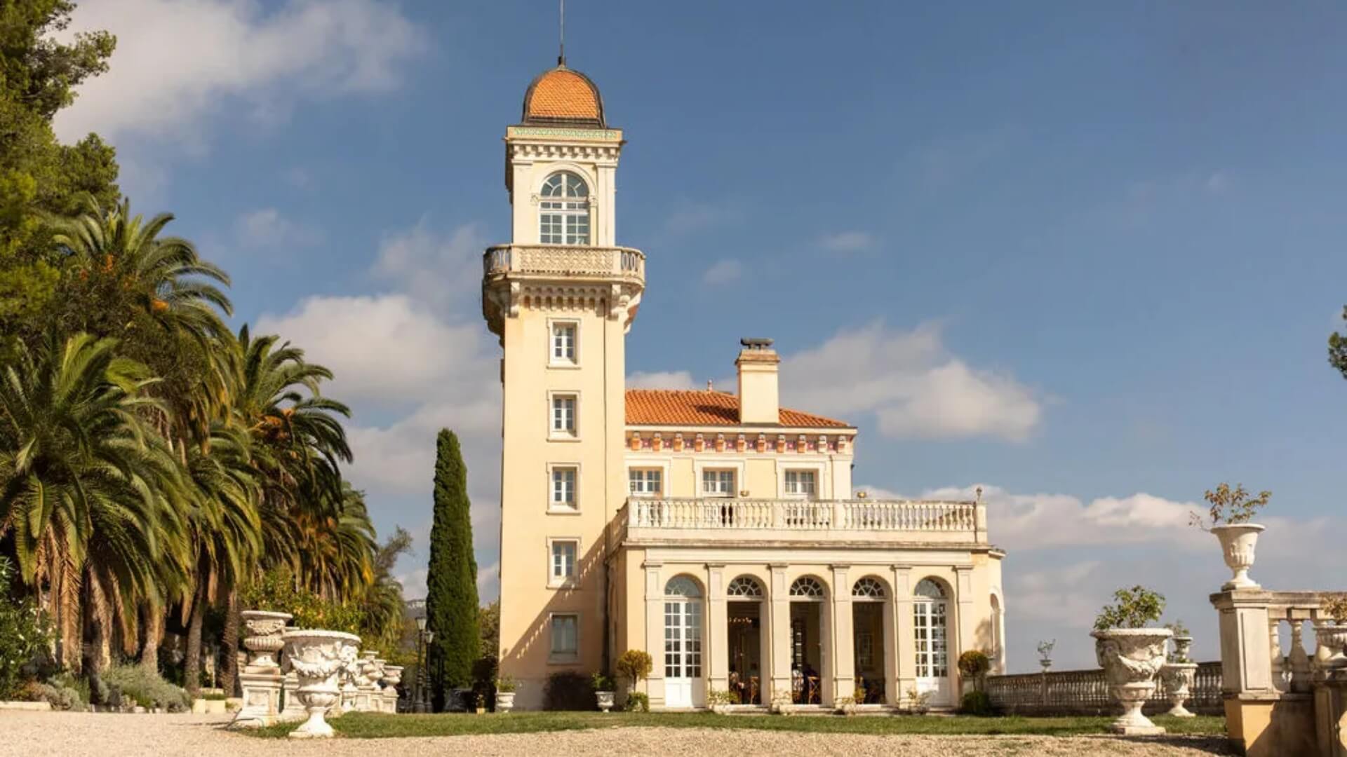 Chateau Saint Georges in Grasse overlooking the Côte d’Azur, surrounded by palm trees.