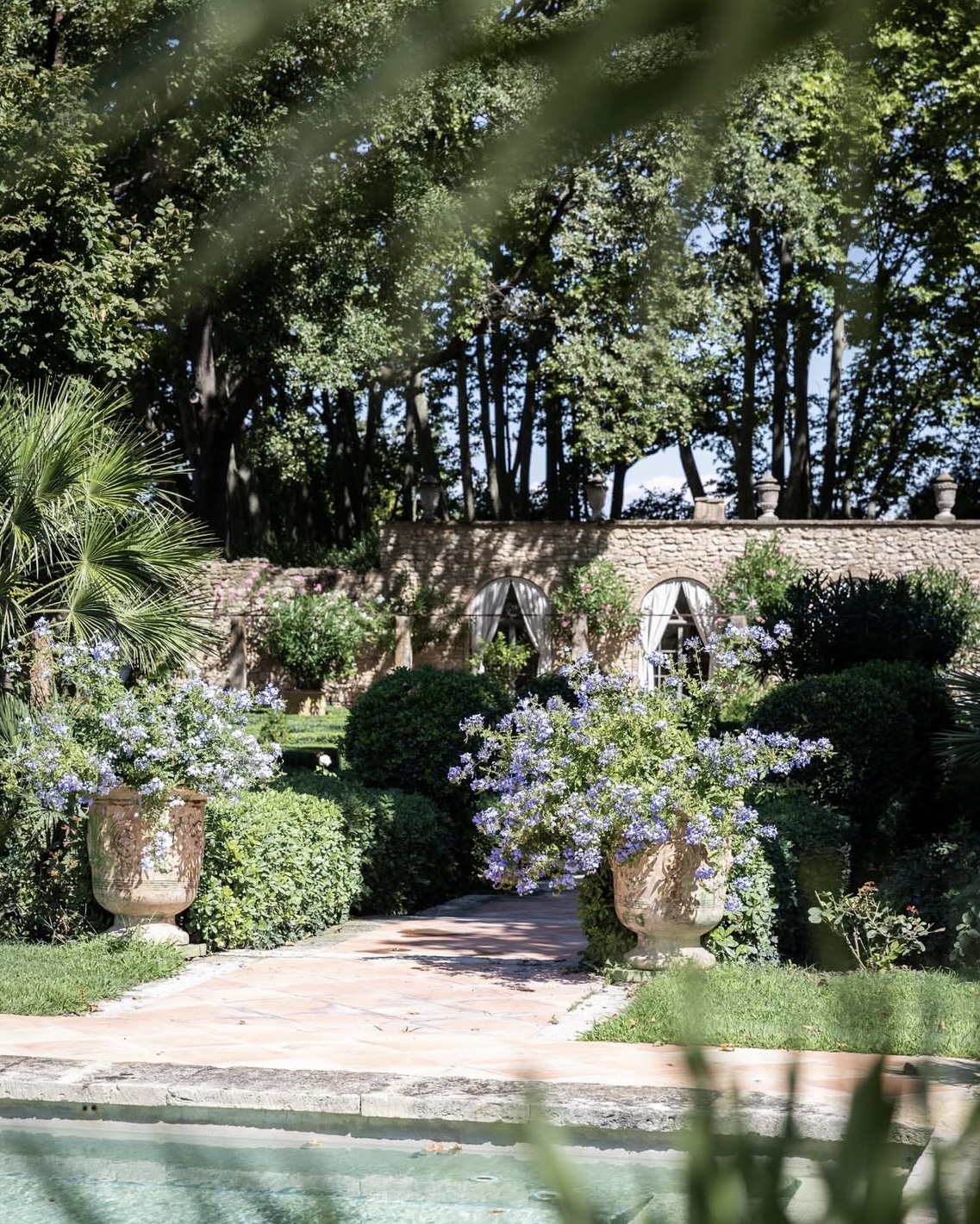 Swimming pool and lush garden courtyard at the Domaine de Fontenille hotel in Provence, France.