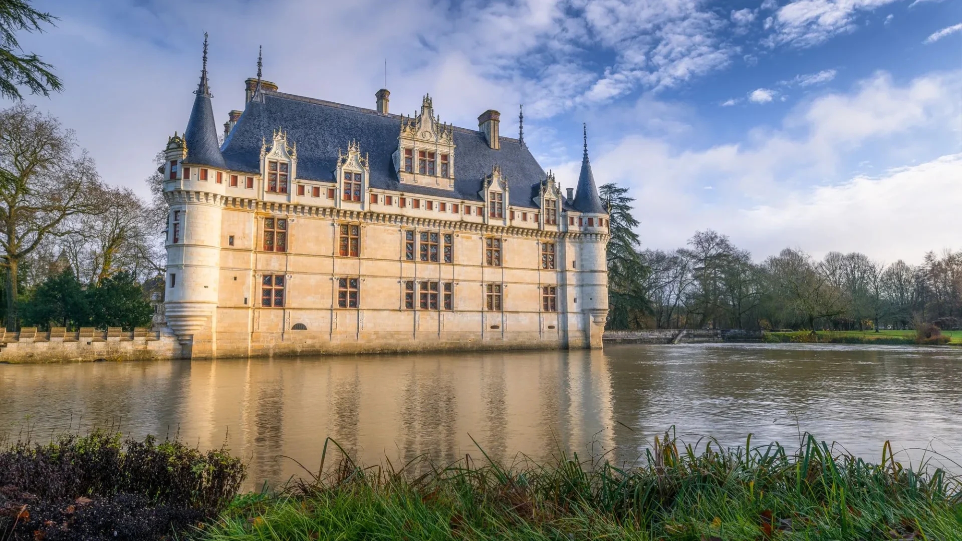Château d'Azay le Rideau exterior in the Loire Valley, France along a gentle river.