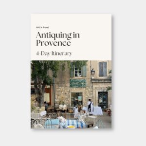 Cover of the “Antiquing in Provence” travel itinerary by My French Country Home, featuring a city center scene and French antiques.