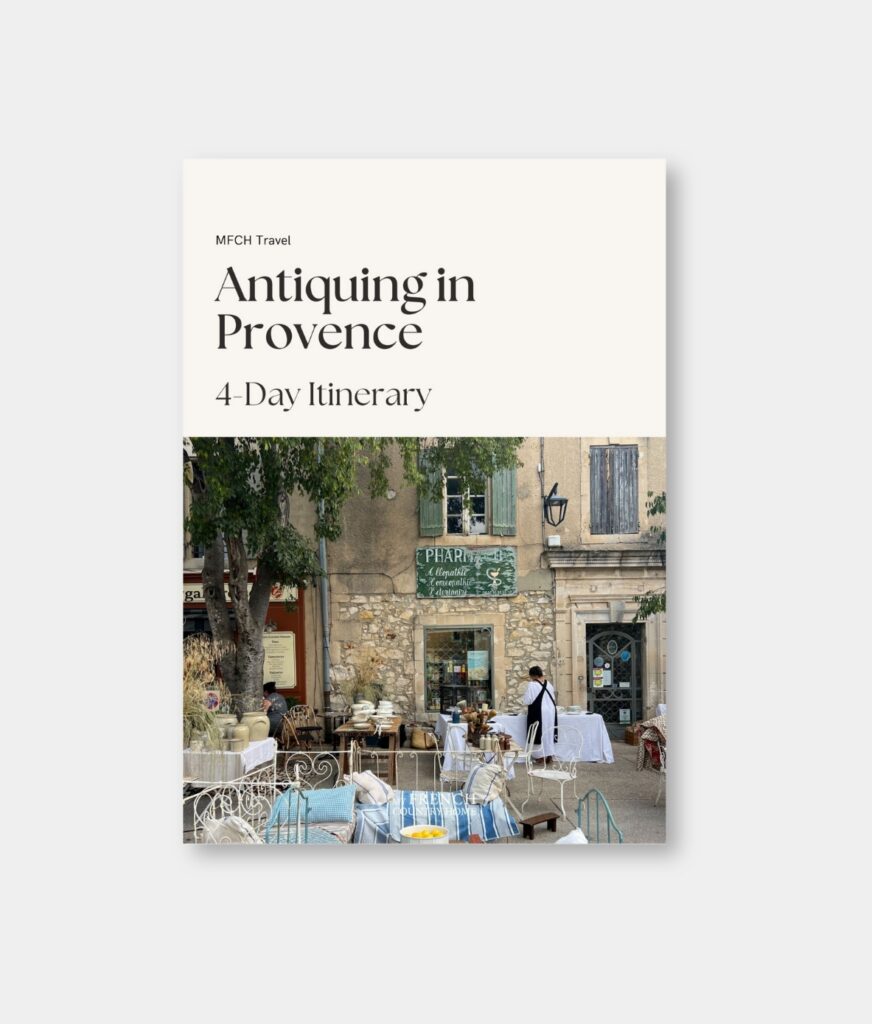 Cover of the “Antiquing in Provence” travel itinerary by My French Country Home, featuring a city center scene and French antiques.