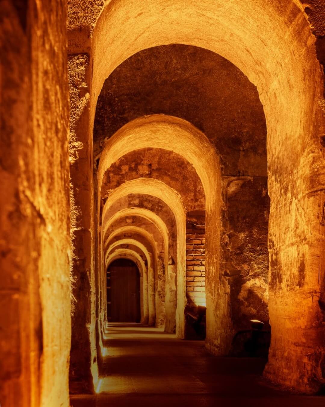 Dimly lit Veuve Clicquot and G.H. Mumm wine cellar in Champagne, France.
