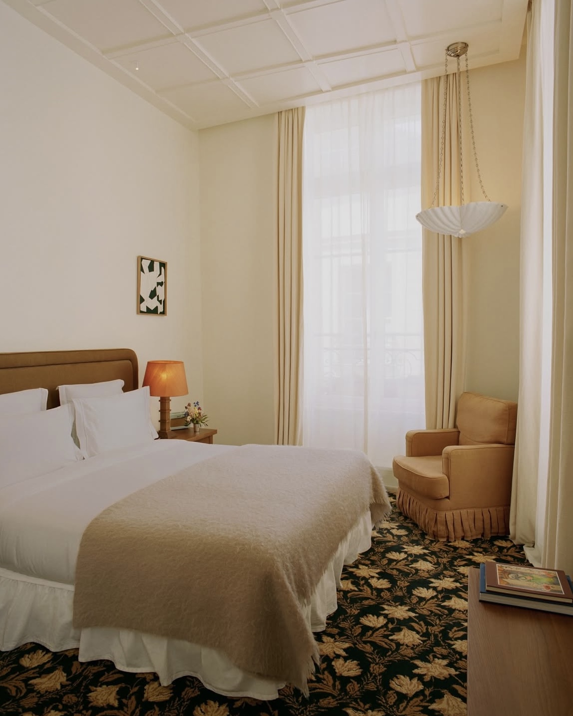 Chateau Voltaire boutique hotel room in Paris, France with fresh white linens and bright natural light.