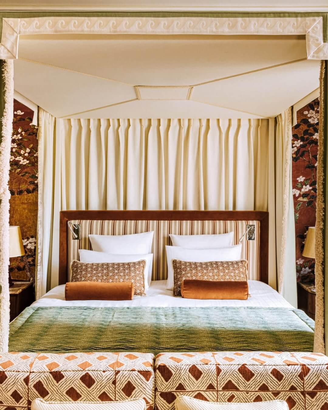 Le Saint James luxury hotel room in Paris, France with a canopied bed and ornate patterned linens.