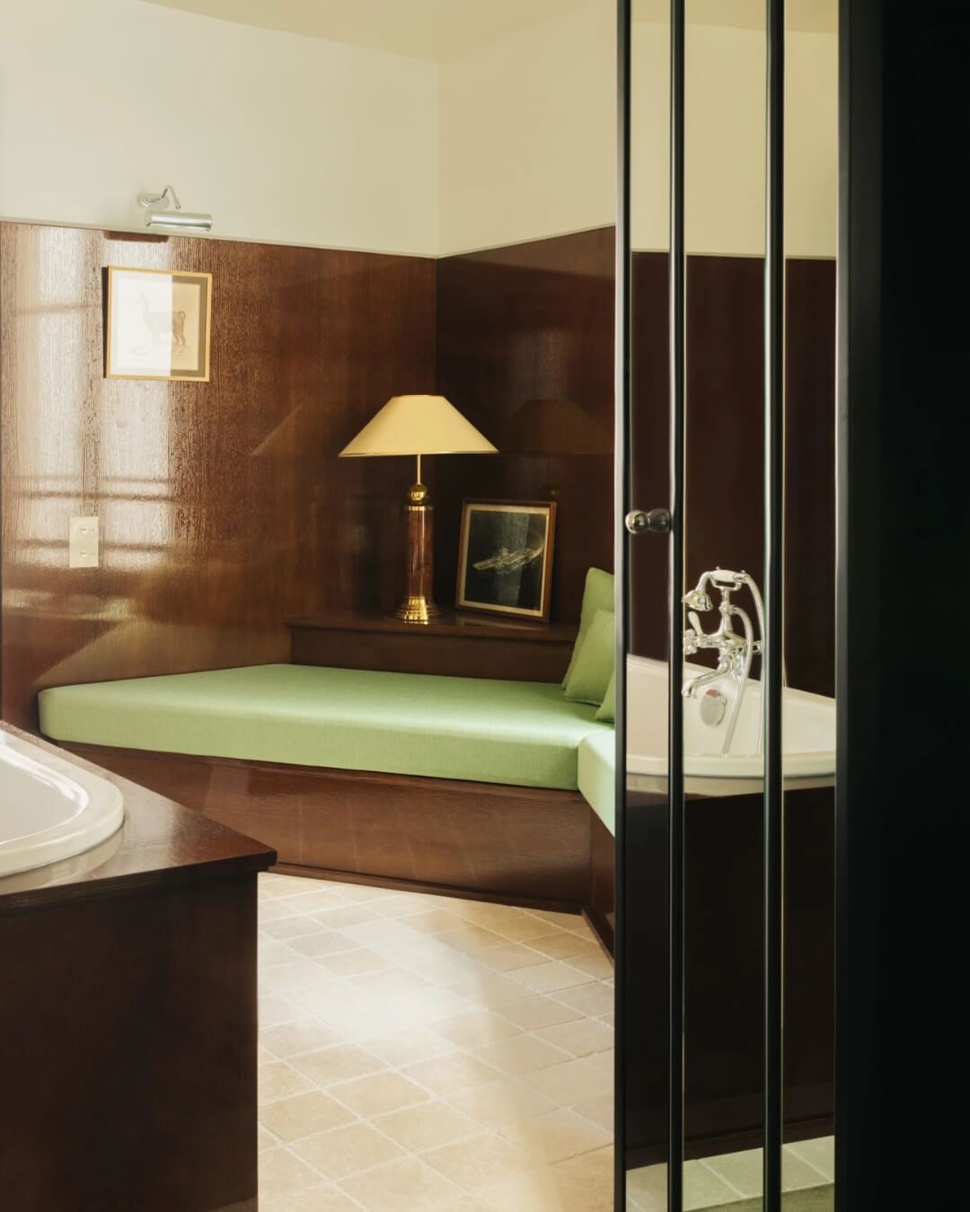 Art Deco bathroom at Les Suites Cinabre in Paris, featuring a jacuzzi style tub framed by dark wood.