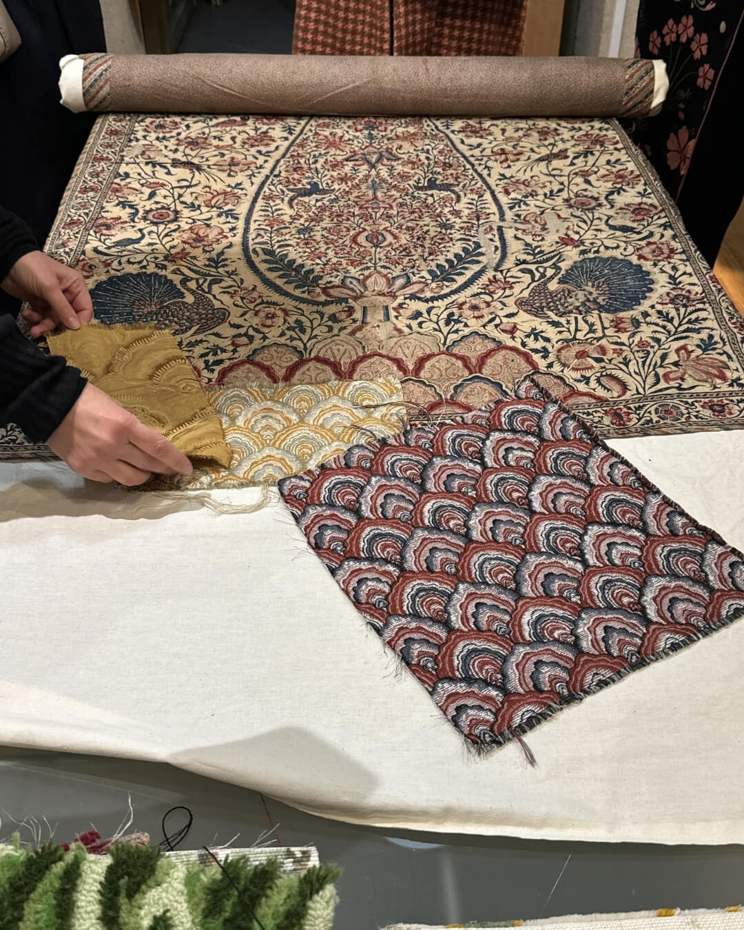 Rough-cut woven antique textiles styled side by side at a French market in Paris.