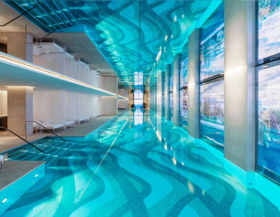 Cheval Blanc luxury spa in Paris featuring an indoor swimming pool with unique floor tiles and mirrored ceilings.