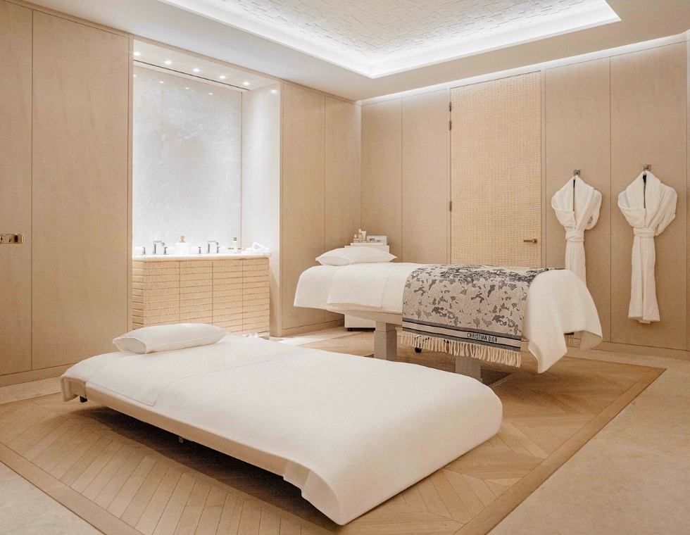 Cheval Blanc luxury spa with couples massage tables and hanging robes.