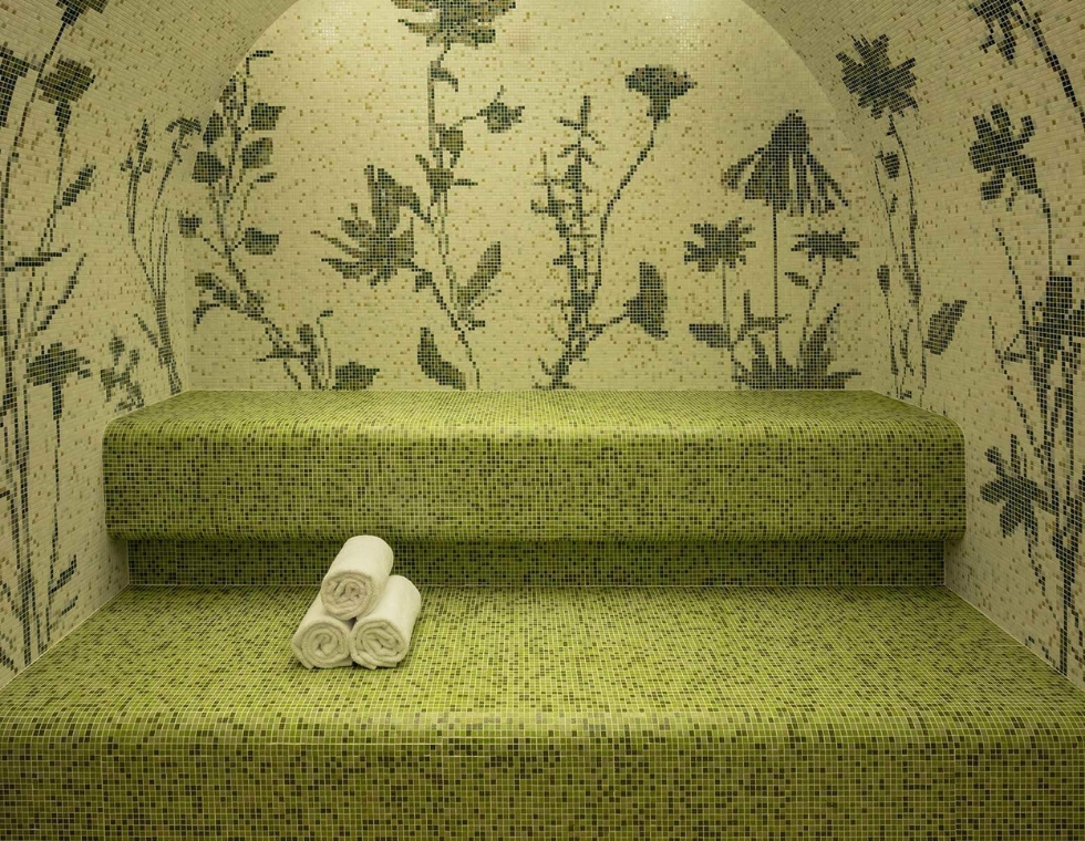 La Fantaisie Spa in Paris featuring a sauna with delicate green tiles and floral motifs.