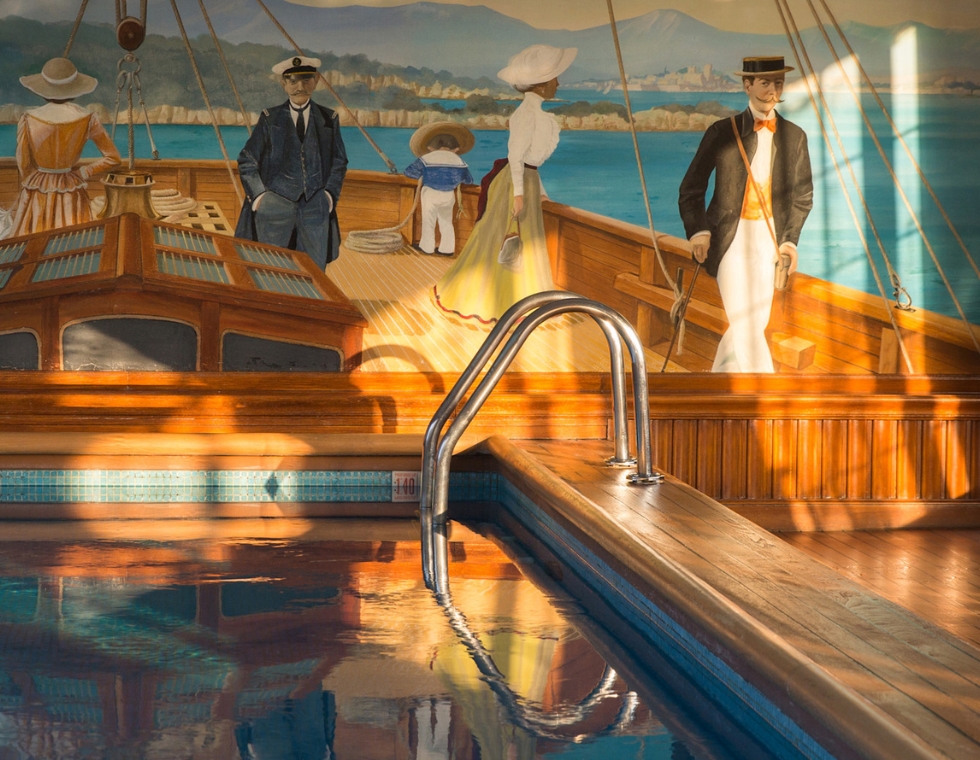 Le Bristol Spa swimming pool in Paris with wood accents and painted walls featuring a nautical scene.