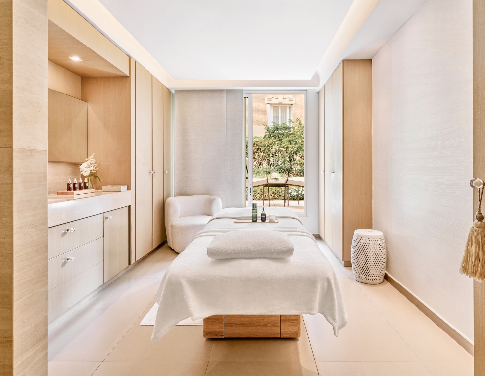 Le Bristol Spa in Paris with a massage table facing a sunny balcony.