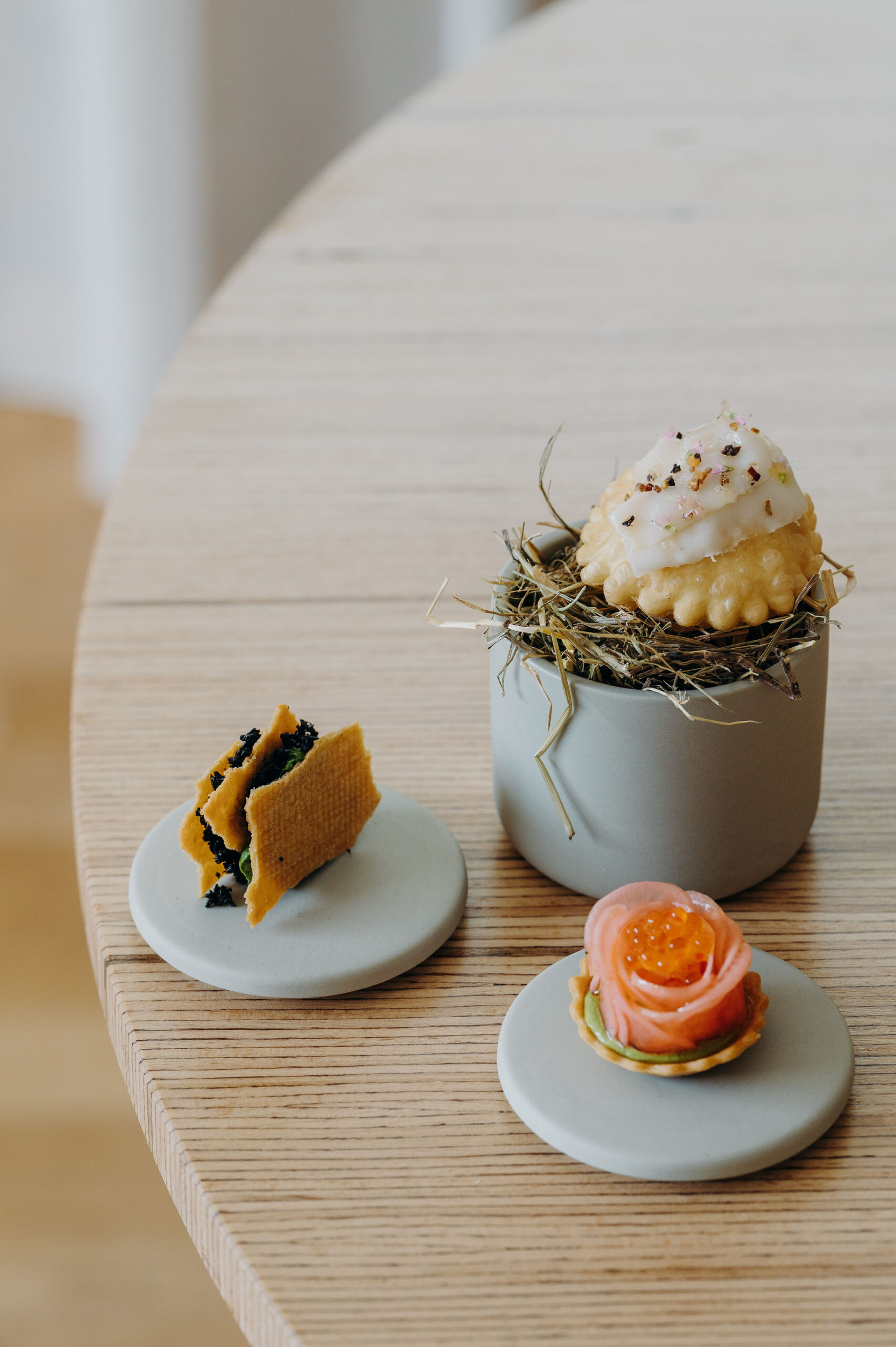 Assorted French pastries and savory bites arranged on a restaurant table.