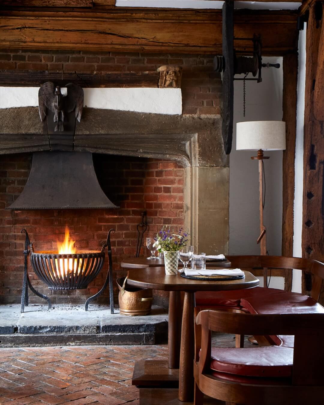 The Star Hotel dining room with an open fireplace and intimate wood tables.