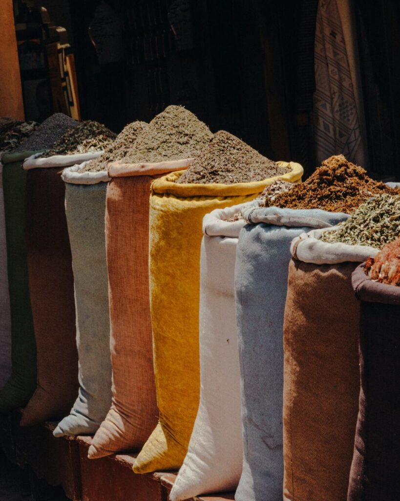 Colorful woven sacks of spices on display at a Moroccan souk.