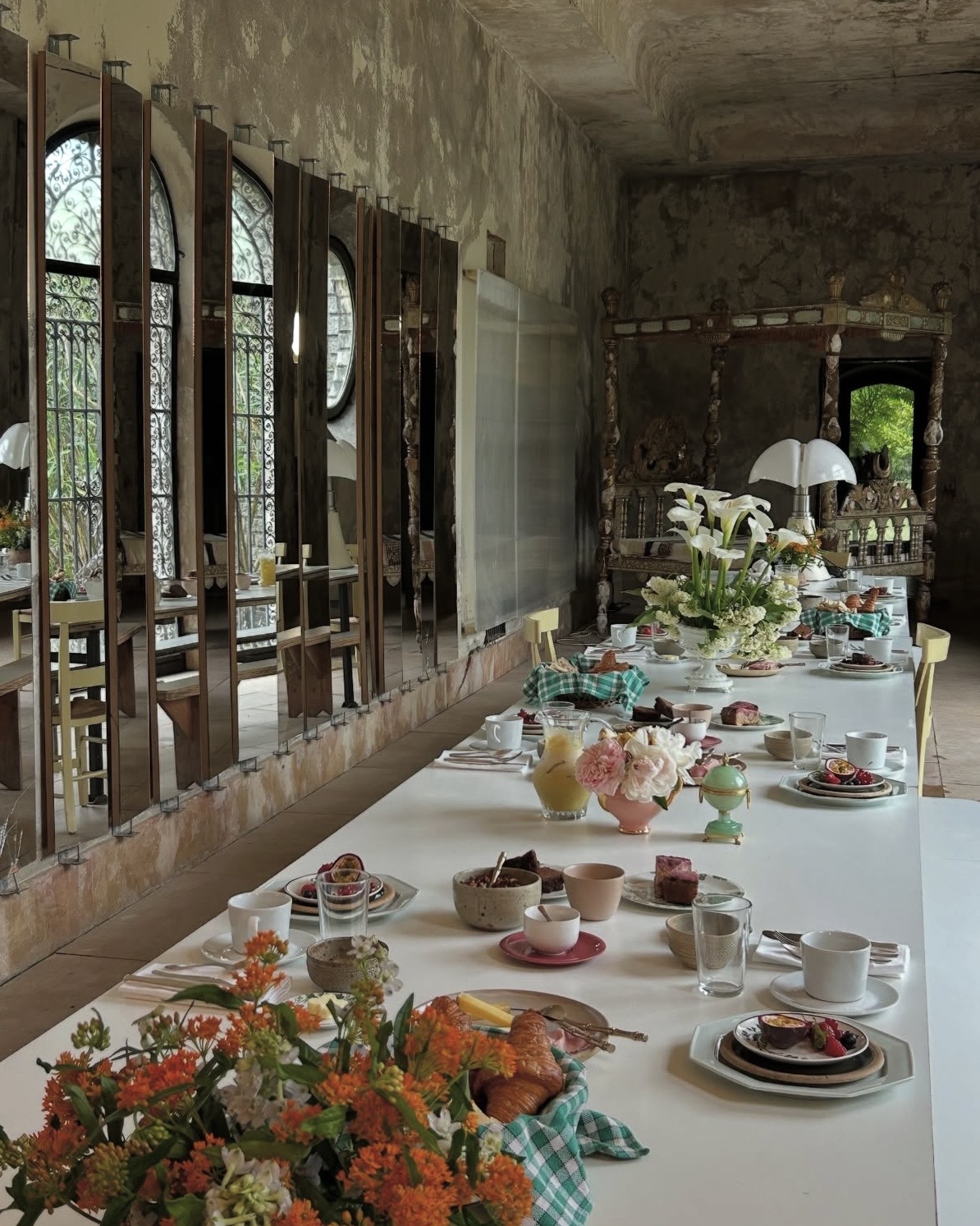 Villa Magnan dining room in Biarritz, featuring arranged place settings, colorful dishes, and freshly cut flowers.