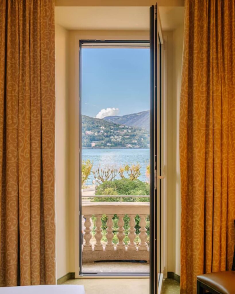 Luxury hotel window and terrace overlooking Lake Como.