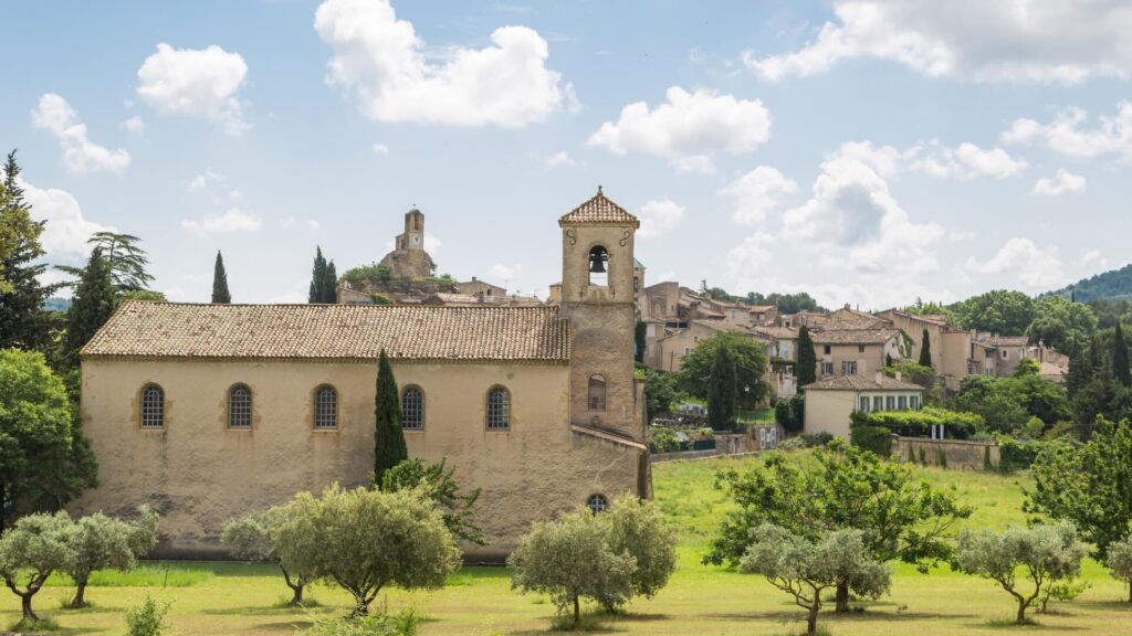Historic local chapel and lush olive grove in Provence.