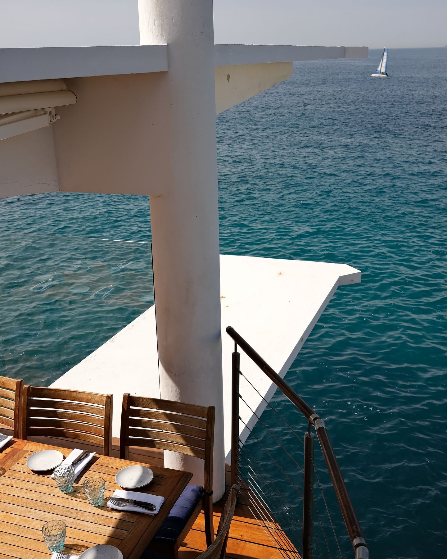 Luxury restaurant terrace in the French Riviera with views of the blue Mediterranean Sea.