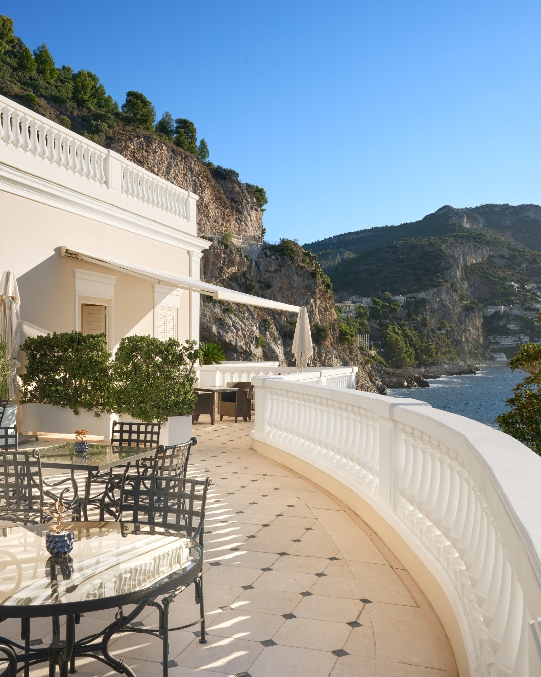 Cap Estel restaurant terrace with marble floors and cliffside ocean views along the French Riviera.