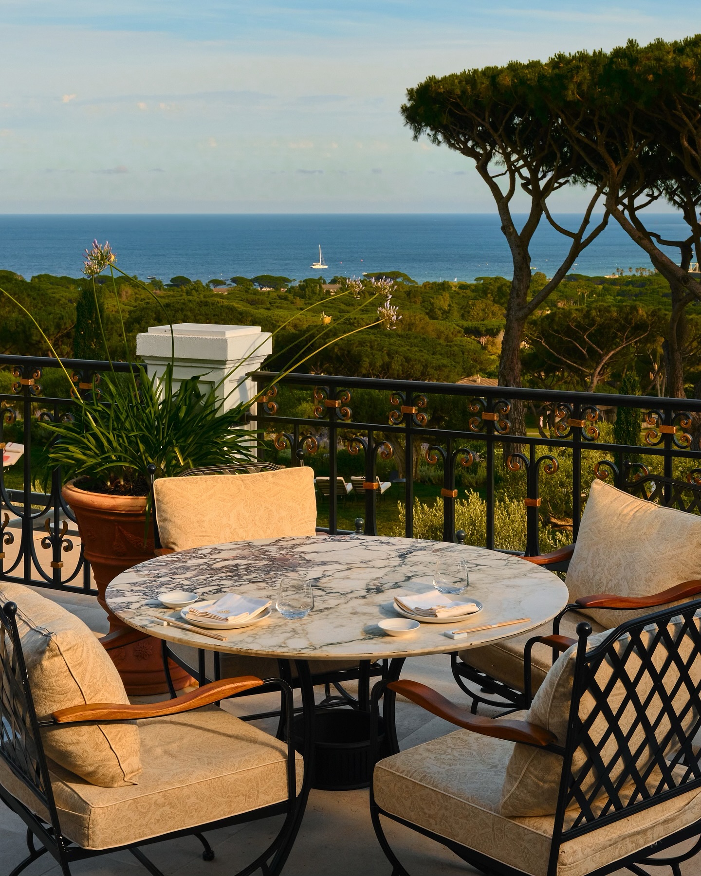 Château de la Messardière five star hotel terrace with lush garden chairs over looking lush greenery and the Mediterranean Sea along the French Riviera.
