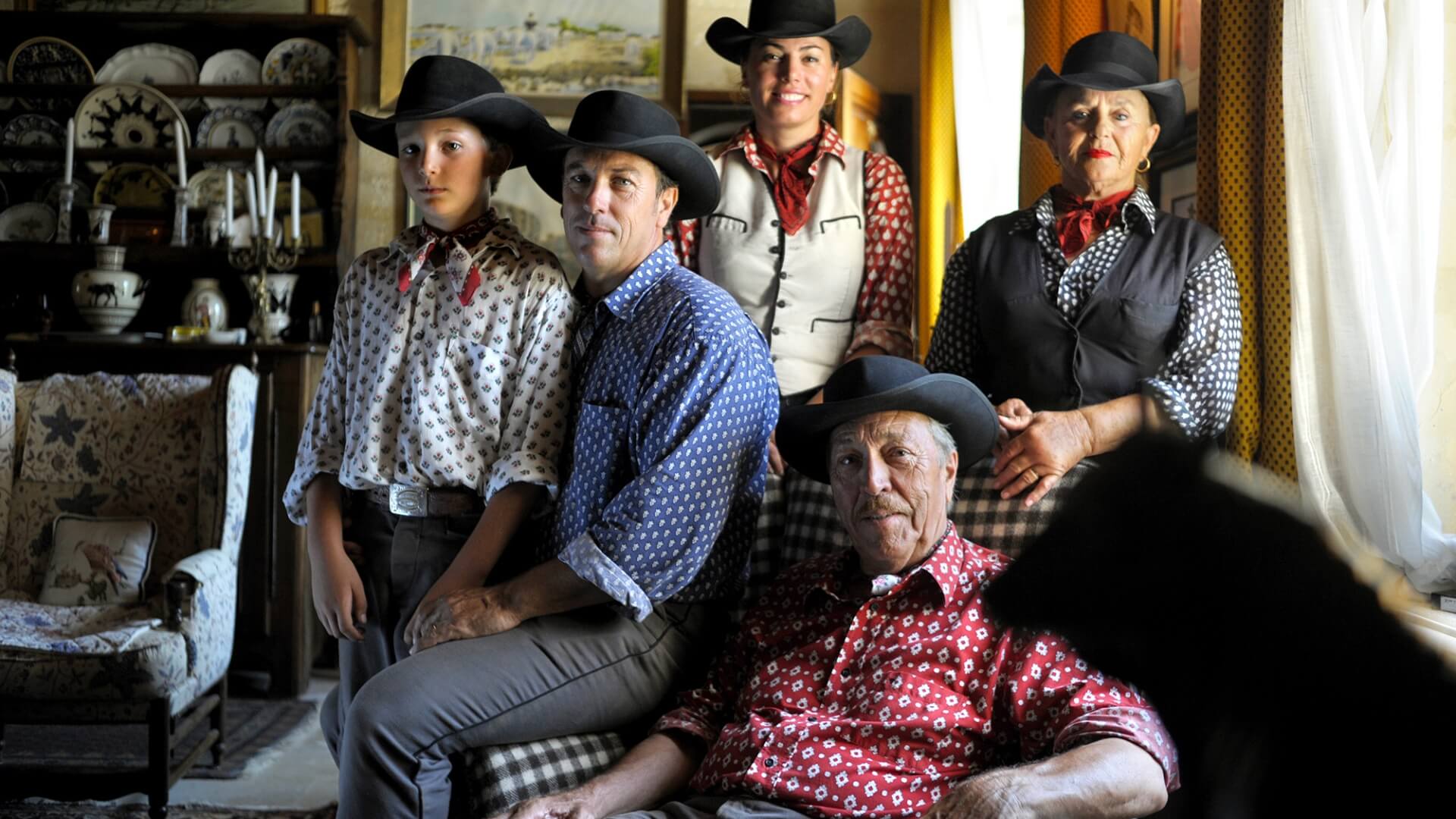 Manade Laurent - Les Marquises family photo with grandparents, parents, and a child posing in a country style salon.