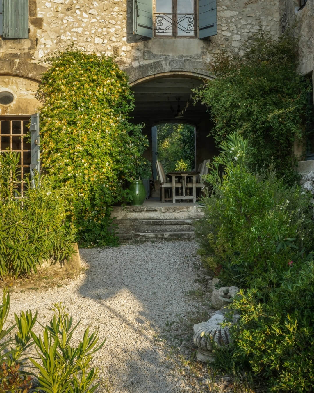 Pebbled garden path to a covered terrace at the Terres de Pierre domain in Provence, France.