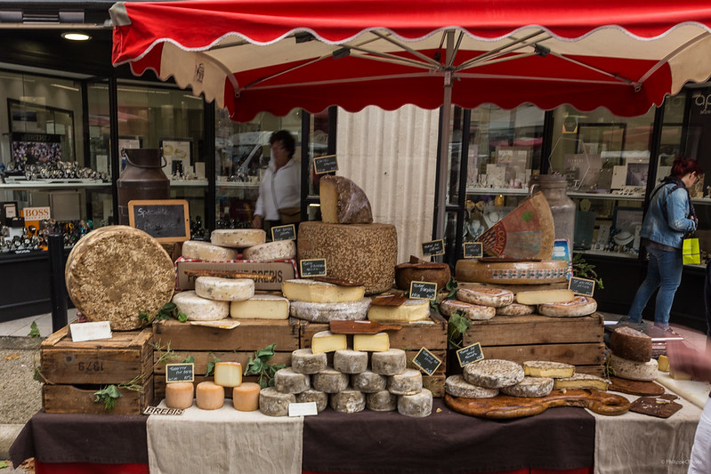 Market stall with fresh French cheeses on display at Le Marché de Saint-Rémy-de-Provence.